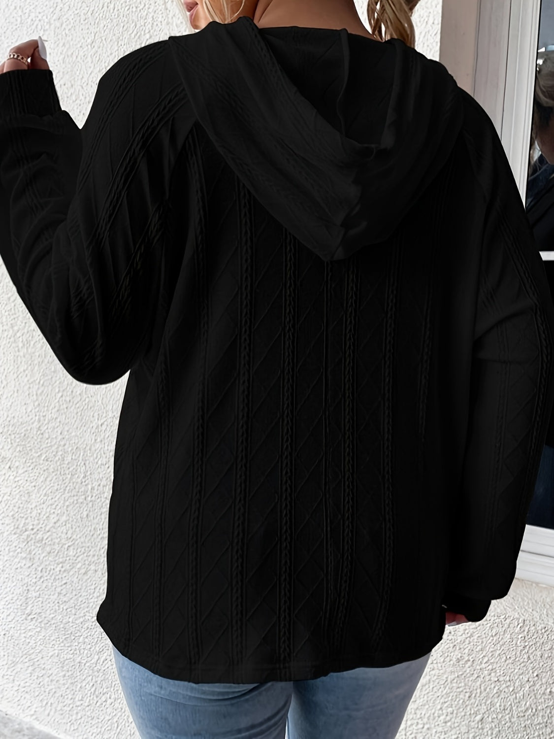 Black textured knit raglan hoodie with cable knit detail.