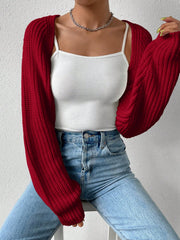 Burgundy acrylic knit bolero shrug with long balloon sleeves over a white tank top and jeans.
