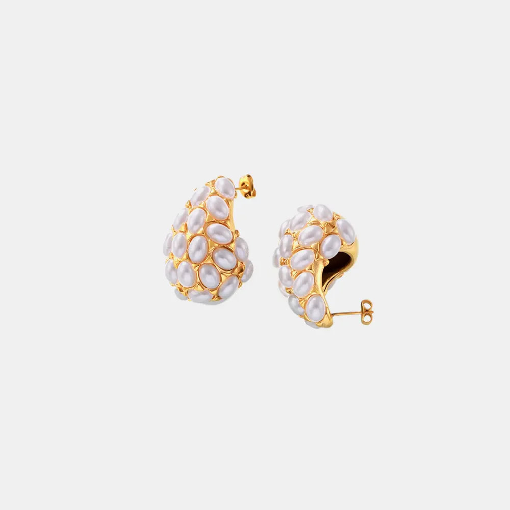 Gold sculptural hoop earrings with clustered white pearls