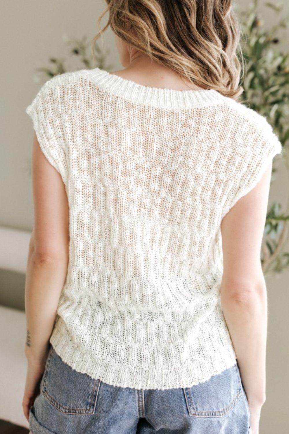 Beige textured knit V-neck shell top with cap sleeves and a relaxed fit.