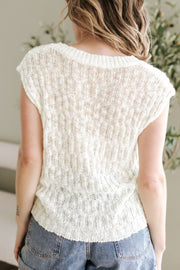 Beige textured knit V-neck shell top with cap sleeves and a relaxed fit.