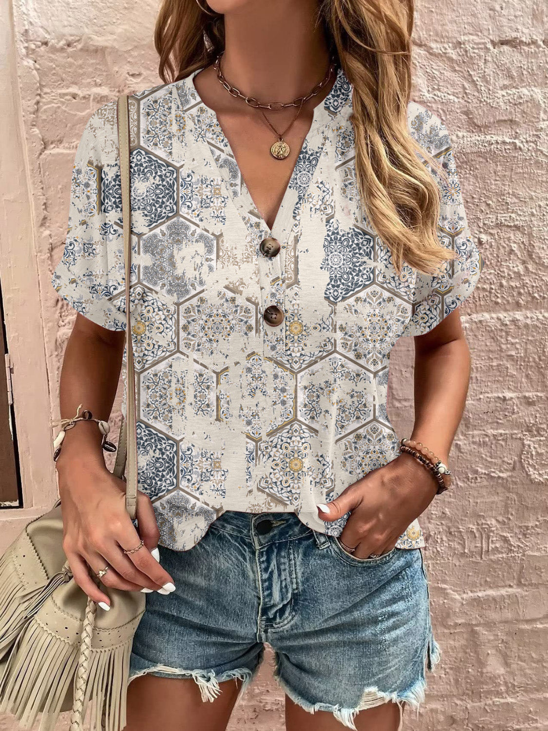 Bohemian tapestry henley blouse with v-neck and short sleeves in a geometric tile print.