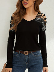 Black ribbed knit blouse with cold shoulder cutouts and rhinestone embellishments on sleeves.