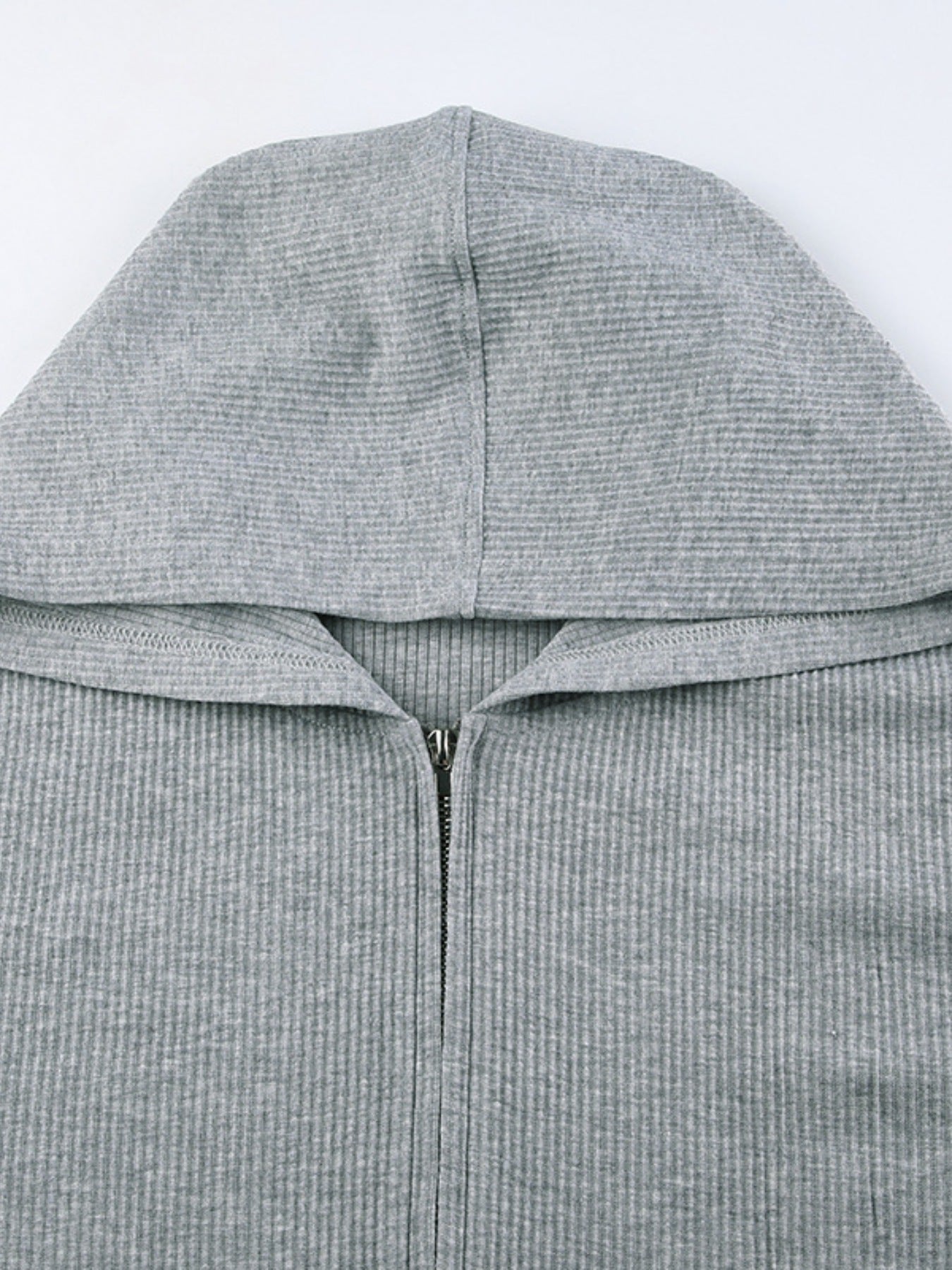Grey ribbed knit zip-up hoodie with a hood and a relaxed fit.