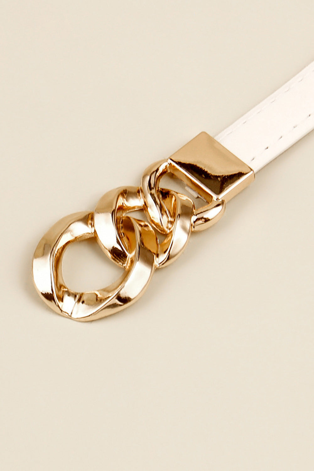 White leather belt with gold chain link buckle detail