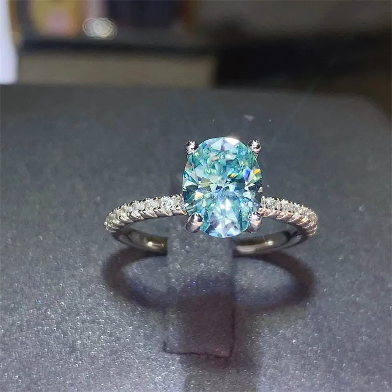 Silver ring with oval aqua moissanite and pavé band