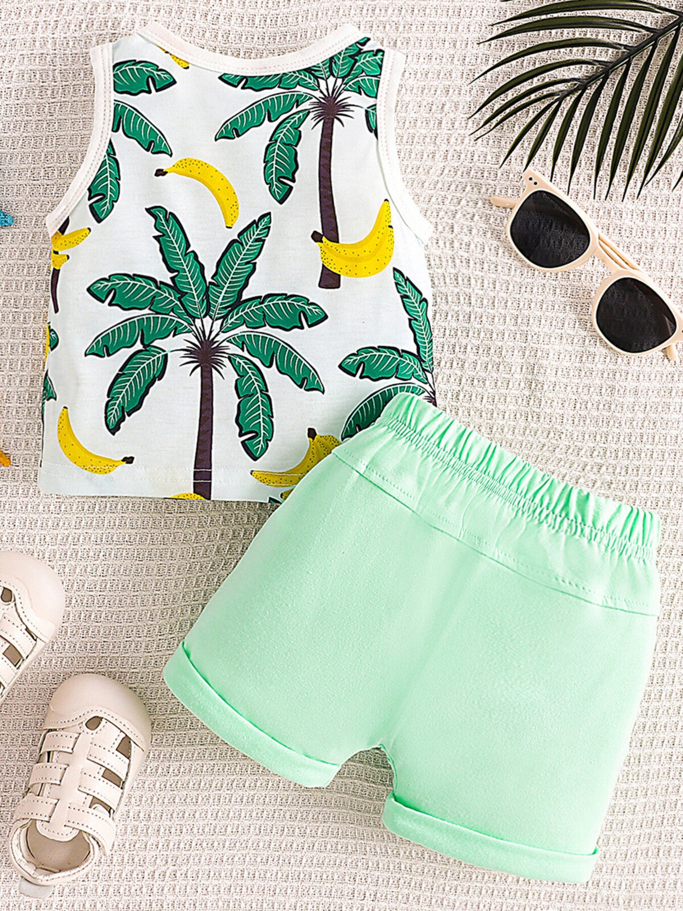 Baby set with tropical palm and banana print tank top and light green drawstring shorts.