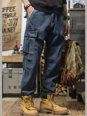 Men's vintage wash denim cargo jeans with multiple pockets and elastic cuffs.
