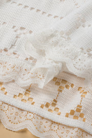 White lace peplum blouse with scalloped hem detail and breathable fabric.