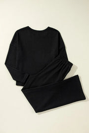 Black ribbed loungewear set with crewneck top and wide-leg pants.