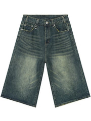 Wide-leg denim culottes in faded blue wash with whiskering detail.