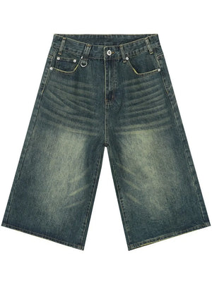 Wide-leg denim culottes in faded blue wash with whiskering detail.