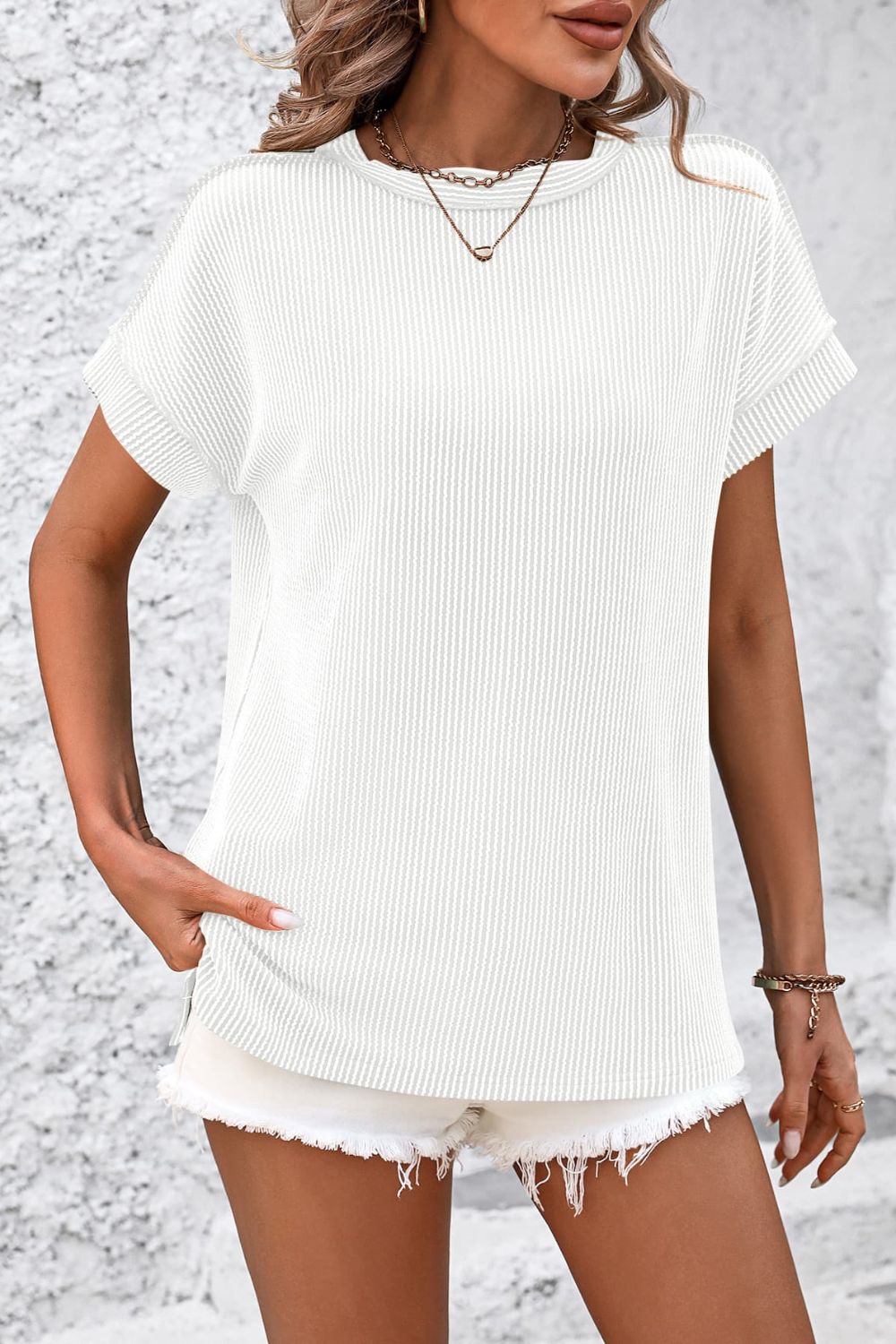 White vertical ribbed tunic tee with split hem and cuffed short sleeves.