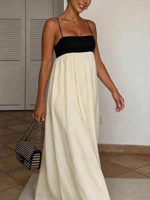 Maxi dress with black bodice, cream skirt, spaghetti straps, and square neckline.