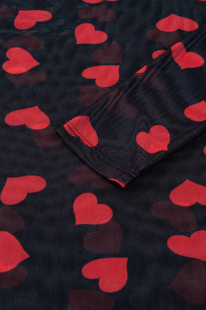 Sheer mesh blouse with red heart print and long sleeves.
