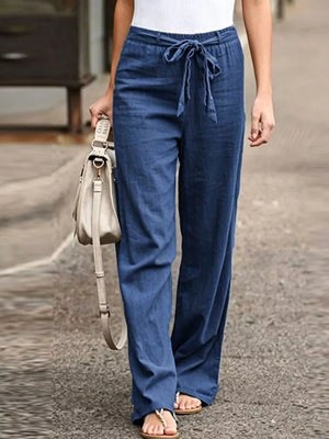Blue maternity pants with relaxed wide legs and a tie detail at the waist.
