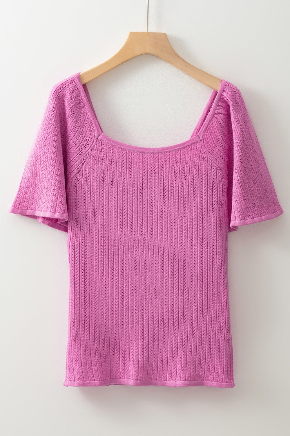 Red-violet knit blouse with square neckline and flutter sleeves.