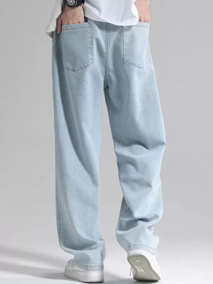 Men's light blue loose fit jeans with drawstring detail and back pockets.