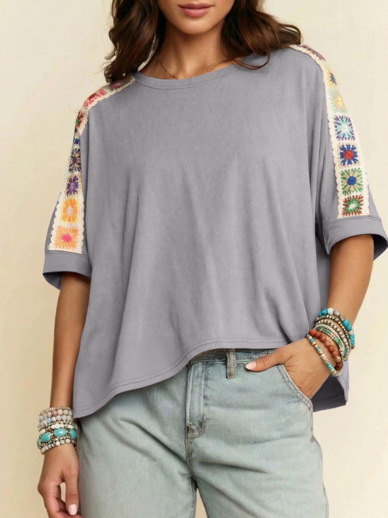 Grey t-shirt with colorful crochet detail on sleeves and shoulders, loose fit, crew neck.