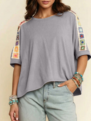 Grey t-shirt with colorful crochet detail on sleeves and shoulders, loose fit, crew neck.