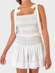 White smocked bodice set with rainbow stripes and tie straps, paired with white shorts.