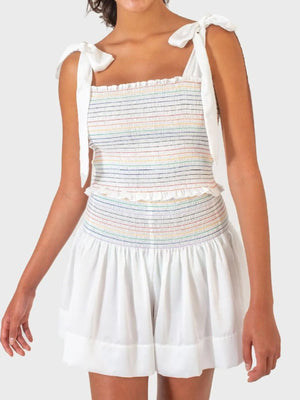 White smocked bodice set with rainbow stripes and tie straps, paired with white shorts.