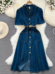 Dark blue denim collared midi dress with short sleeves, gold buttons, belt, and pockets.