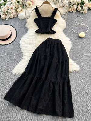 Black eyelet maxi skirt and ruffled crop top set with elastic waistband.