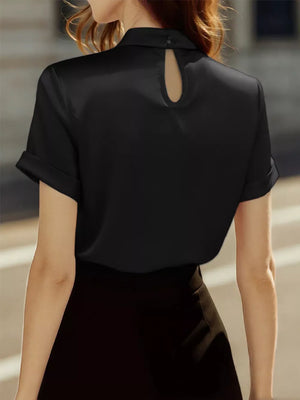 Black satin blouse with short cuffed sleeves and a keyhole neckline detail.
