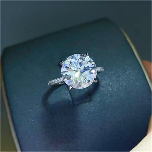 Sterling silver ring with a large round solitaire diamond and pave band.