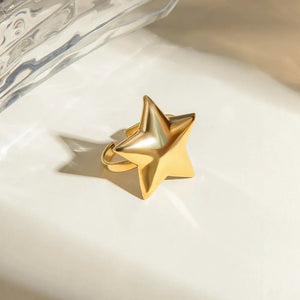 Gold starburst adjustable ring with a bold, sculpted design.