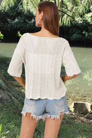 Cream open-knit blouse with scalloped hem and short sleeves, featuring a boat neckline.