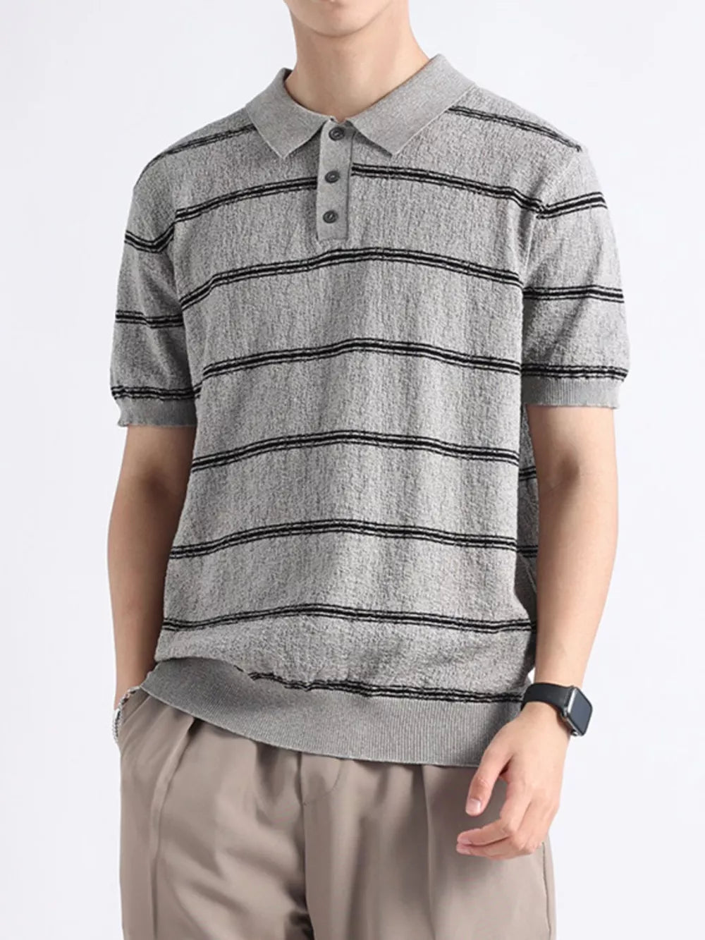 Men's gray knit polo with black horizontal stripes and button accents.
