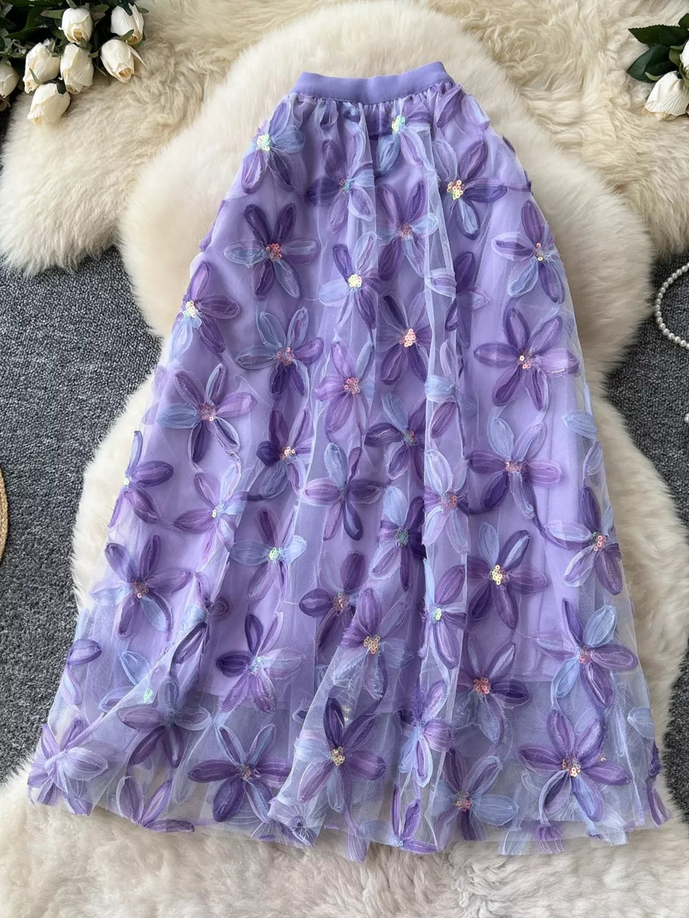 Purple layered midi skirt with embroidered floral appliques and sequins.