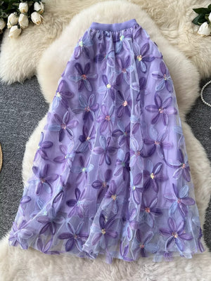 Purple layered midi skirt with embroidered floral appliques and sequins.