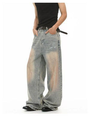 Relaxed fit vintage wash jeans in blue denim with distressed details and a baggy cut.