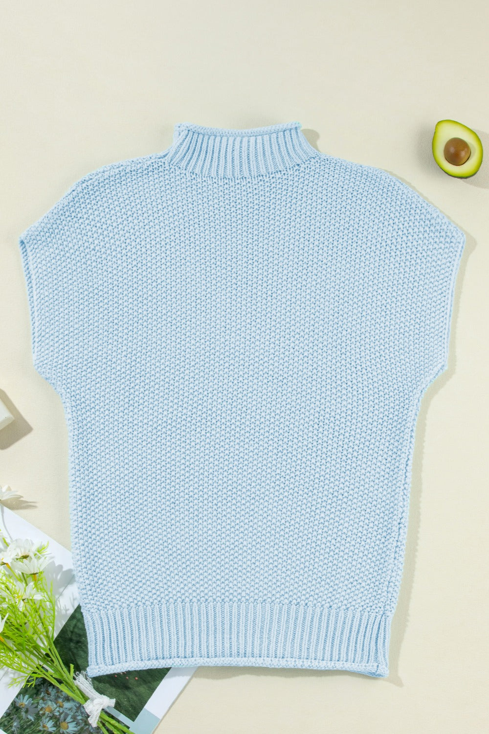 Light blue boxy knit turtleneck sweater shell with short sleeves and ribbed trim.