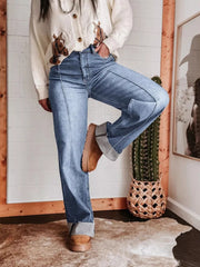 Light blue denim wide-leg jeans with buttoned pockets and cuffed hems.
