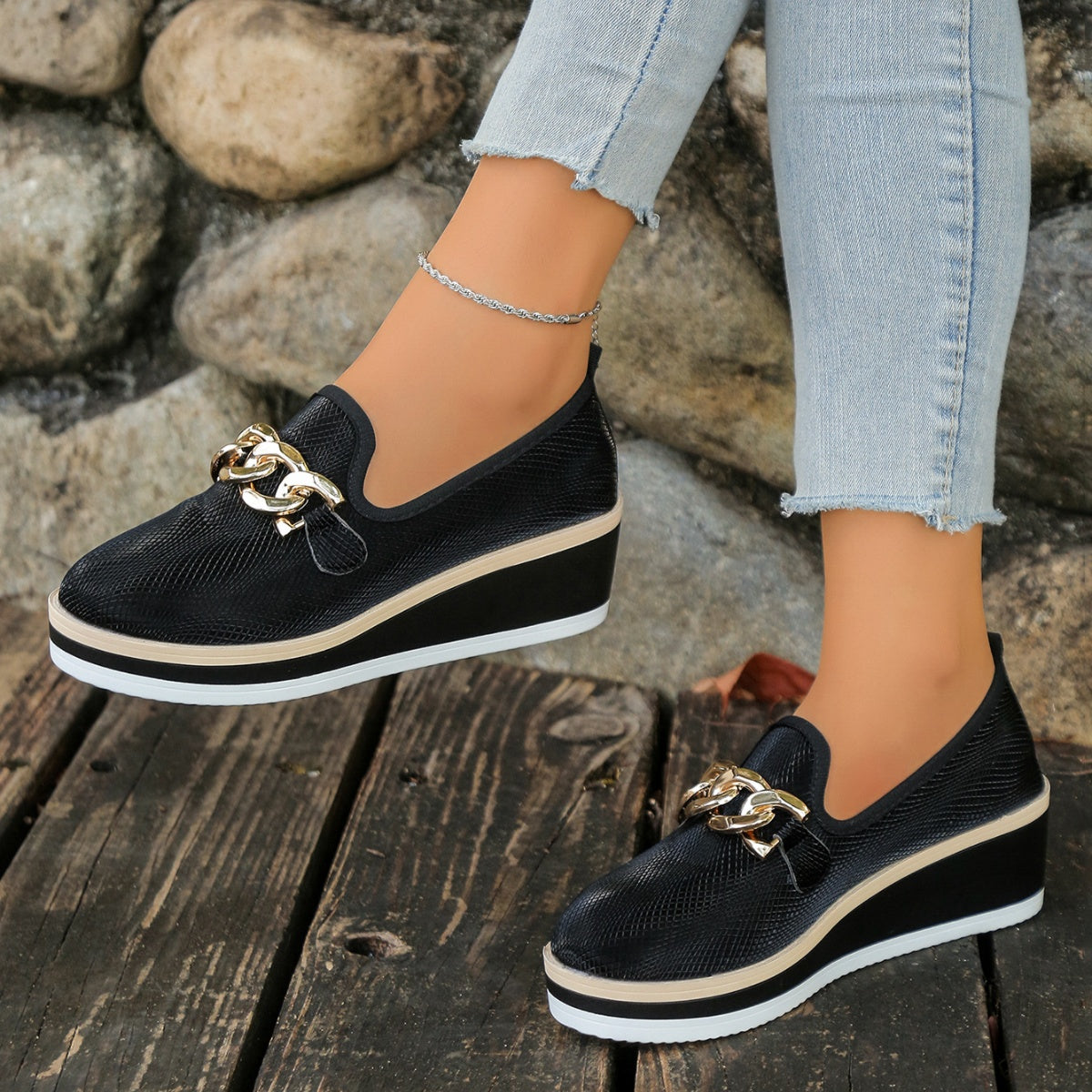 Black wedge loafers with gold chain detail and layered sole