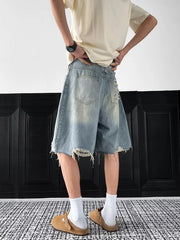 Light-wash distressed denim shorts with raw hem and ripped details.