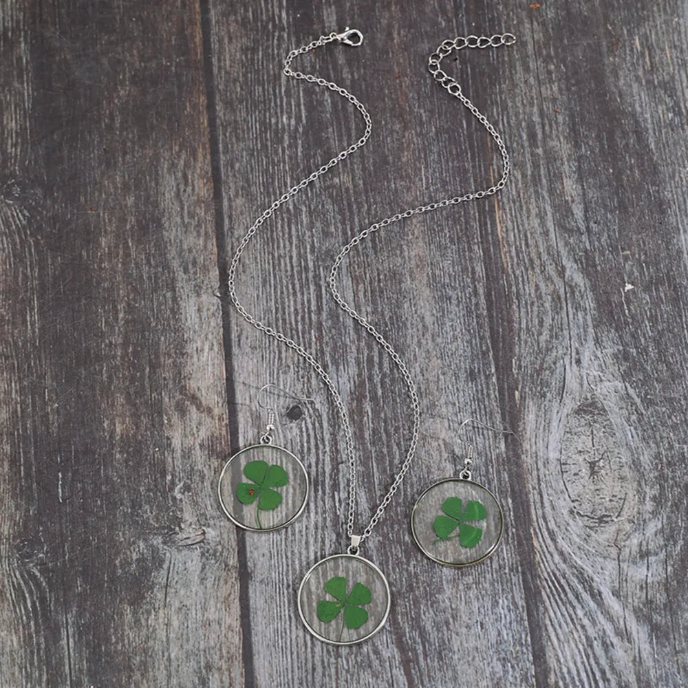 Pressed clover resin jewelry set with silver chain necklace and matching earrings.