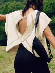 Apricot t-shirt with exposed seams and heart cutout back detail.