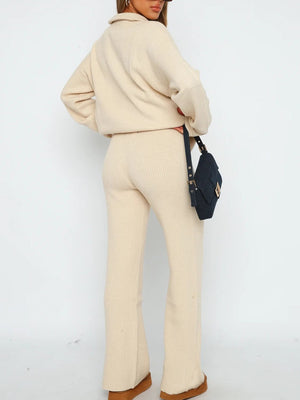 Ribbed knit lounge set in tan featuring quarter-zip top and flared pants.