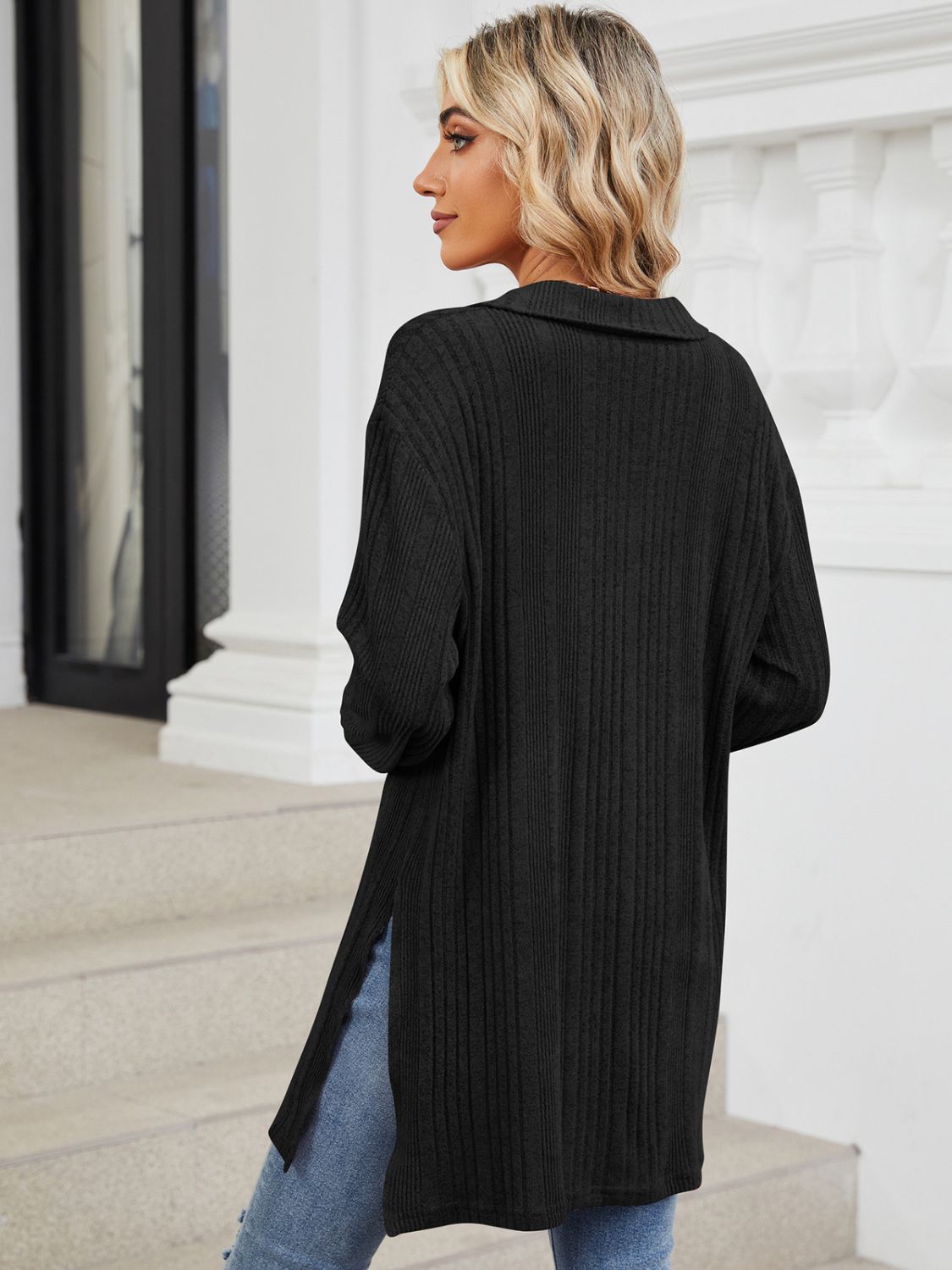 Black ribbed knit collared tunic top with slit hem and long sleeves.