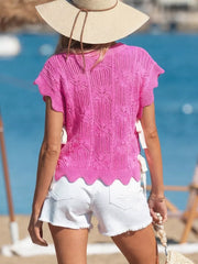 Chic openwork knit sweater vest in pink with cable knit pattern and adjustable side ties.