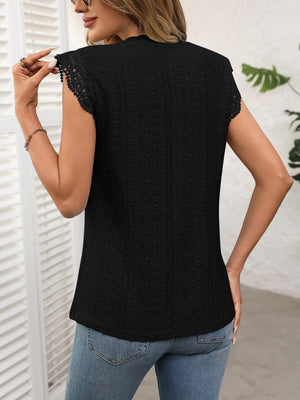 Black eyelet cap sleeve blouse with lace trim and beaded detail on sleeves.