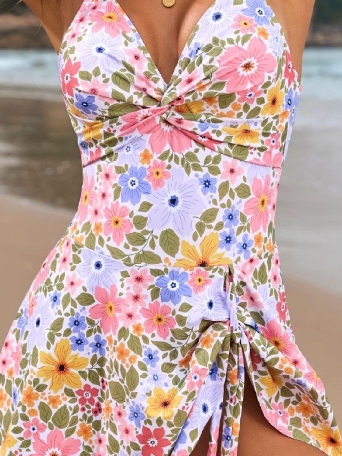 Floral print wrap swim dress with twisted neckline and ruched side slit.