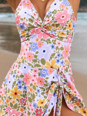 Floral print wrap swim dress with twisted neckline and ruched side slit.