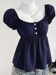 Navy polka dot puff sleeve shirt with square neckline and decorative buttons.