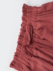 Rust palazzo trousers with ruffled elastic waist and drawstring detail